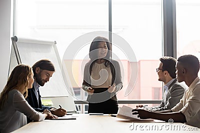 Happy mature korean asian female leader holding negotiations meeting. Stock Photo