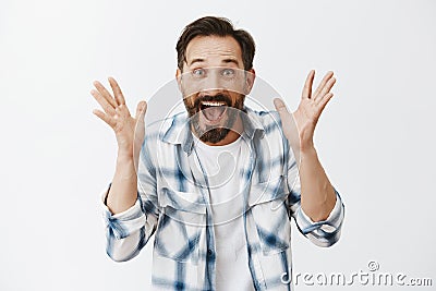 Happy mature male cannot control emotions, feeling happiness and joy, screaming from amazement and excitement, shaking Stock Photo