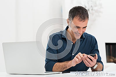 Happy Mature Man Using Cellphone Stock Photo