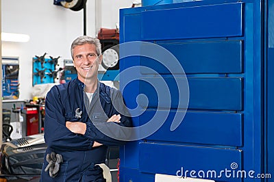 Happy Mature Mechanic In Garage Stock Photo