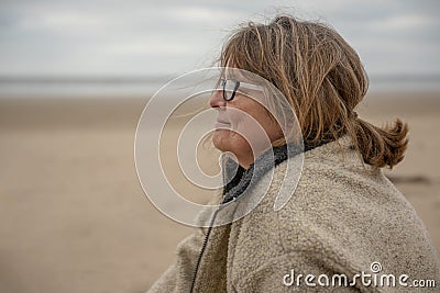 Happy Mature woman in the beach in winter Stock Photo