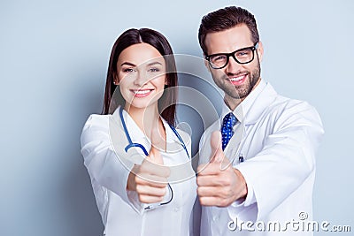 Happy medic workers. Portrait of two doctors in white coats and Stock Photo