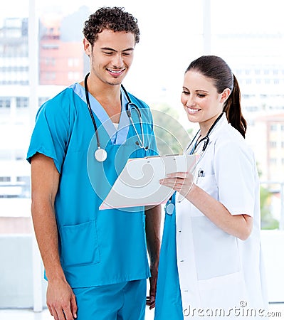 Happy medical partners looking at the diagnosis Stock Photo