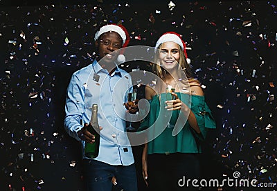 Joyful couple congratulating on christmas with champagne at black background Stock Photo