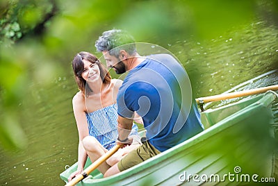 Tilt shot of happy mid adult couple boating in lake during summer Stock Photo