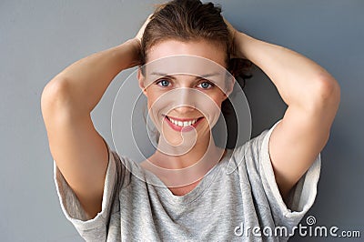 Happy mid adult woman smiling with hands in hair Stock Photo