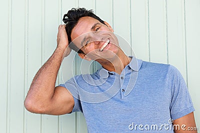 Happy middle age man laughing with hand in hair Stock Photo