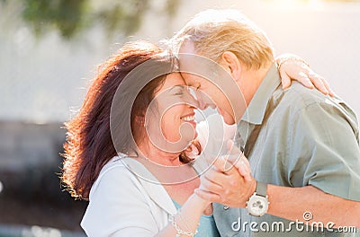 Affectionate Middle Aged Couple Enjoy A Romantic Slow Dance Outside Stock Photo