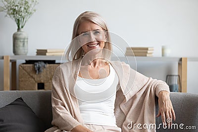 Happy middle aged woman looking at camera at home Stock Photo