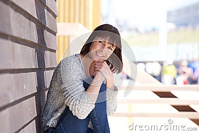 Happy middle aged woman sitting outside Stock Photo