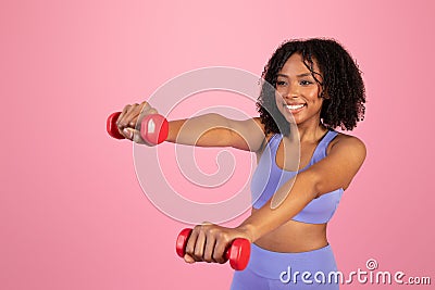 happy millennial african american woman in sportswear doing hand exercises with dumbbells Stock Photo