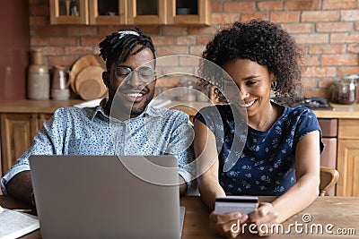 Happy millennial African couple shopping on internet together Stock Photo