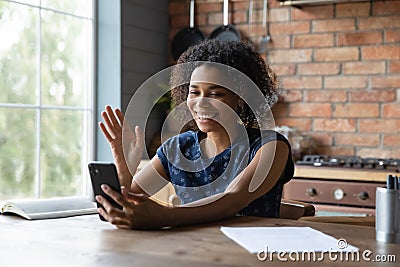 Happy millennial African mixed race girl using smartphone Stock Photo