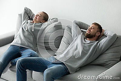 Happy couple relaxing taking nap on cozy sofa at home Stock Photo