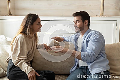 Happy millennial couple talk relaxing in living room Stock Photo