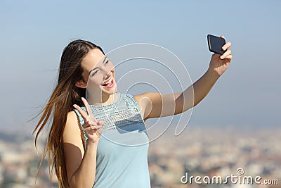 Happy millennial girl taking selfies outdoors Stock Photo