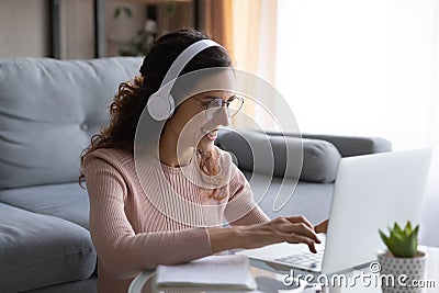 Happy millennial woman student in glasses studying on online courses. Stock Photo