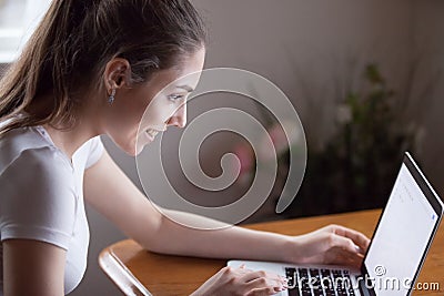 Happy millennial woman working on computer at home Stock Photo