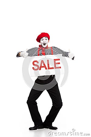 happy mime holding sale signboard and showing thumbs up Stock Photo