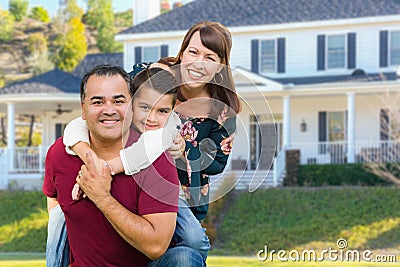 Happy Mixed Race Family Portrait In Front of Their House Stock Photo