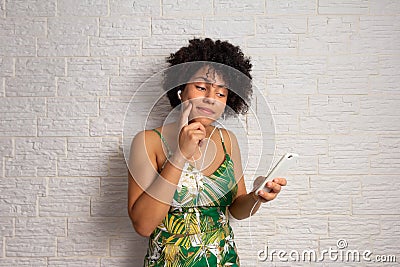 Happy woman with curly hair making an on-line purchase with smart phone. E-commerce, online shopping, communication, Stock Photo