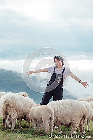 A happy moment of a female farmer and her sheep Stock Photo
