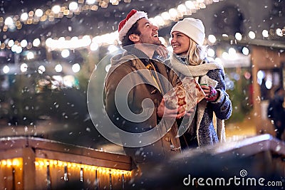 Happy moments of young couple in love at christmas festival in the city. Festival, love, relationship, Xmas, snow Stock Photo