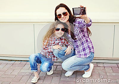 Happy mother and child taking self-portrait on smartphone Stock Photo