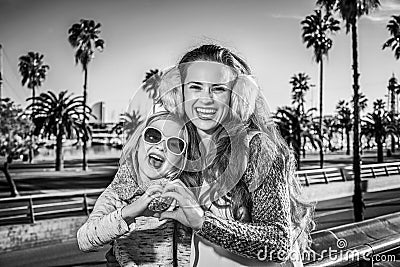 Happy mother and child tourists showing heart shaped hands Stock Photo