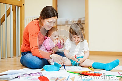 Happy mother with children plays at home Stock Photo