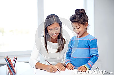 Happy mother and daughter drawing with pencils Stock Photo