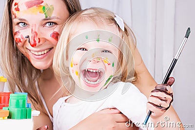 Happy mother and daughter painting Stock Photo