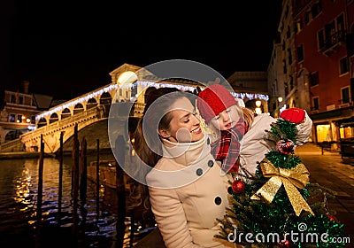 Happy mother and daughter in Venice looking on Christmas tree Stock Photo