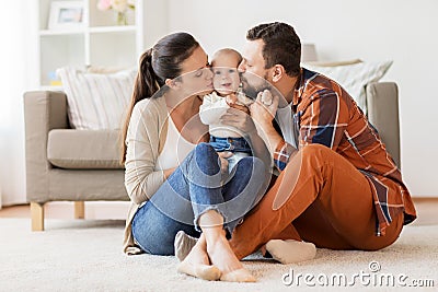 Happy mother and father kissing baby at home Stock Photo