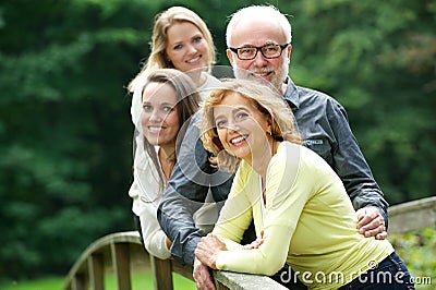 Happy mother and father standing with two daughters outdoors Stock Photo