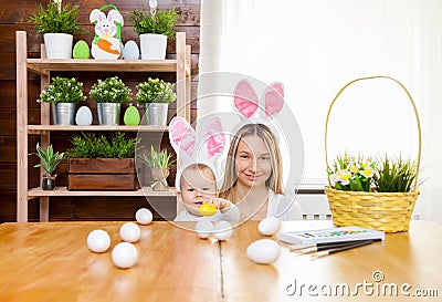 Happy mother and her cute child wearing bunny ears, getting ready for Easter Stock Photo