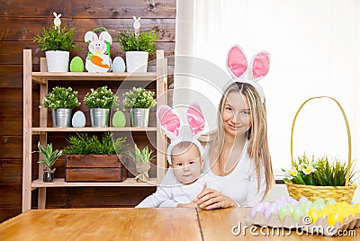 Happy mother and her cute child wearing bunny ears, getting ready for Easter Stock Photo