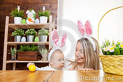 Happy mother and her cute child wearing bunny ears, getting ready for Easter Stock Photo