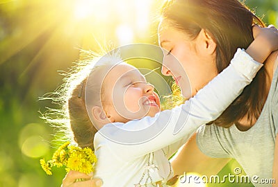 Happy mother and her little daughter outdoor. Mom and daughter enjoying nature together in green park Stock Photo