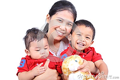 A happy mother holding her two little boys. Stock Photo