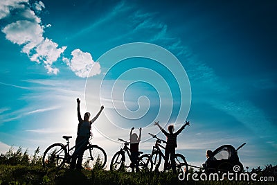 Happy mother with kids biking at sunset, family enjoy bike ride Stock Photo