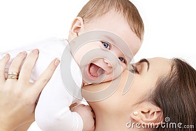Happy mother kissing baby Stock Photo