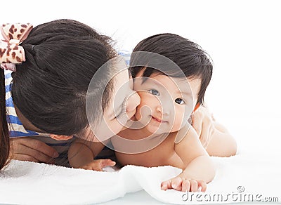 Happy mother kissing smiling child baby Stock Photo