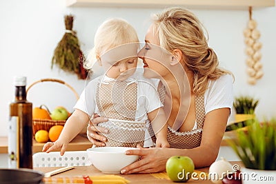 Happy mother and little daughter cooking in kitchen. Spending time all together, family fun concept Stock Photo