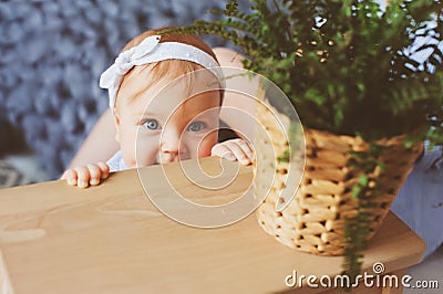 Happy mother and 9 month old baby in matching pajamas playing in bedroom in the morning Stock Photo