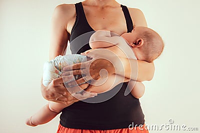 Happy mother with newborn baby infant on hands standing and breasfeeding lacting lactation health and care bonding time Stock Photo