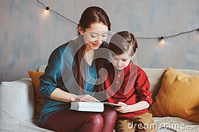 happy mother reading book to child son at home, Stock Photo