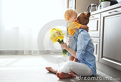 Happy mother`s day! baby son gives flowersfor mother on holiday Stock Photo