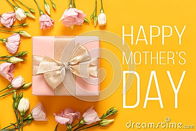 Happy Mother`s Day Background. Bright Yellow and Pastel Pink Colored Mother Day Background. Flat lay greeting card with gift box. Stock Photo