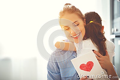 Happy mother`s day! Child daughter congratulates moms and gives Stock Photo